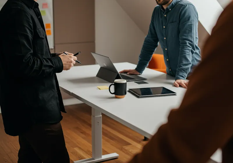Two colleagues reviewing a project together at a standing desk